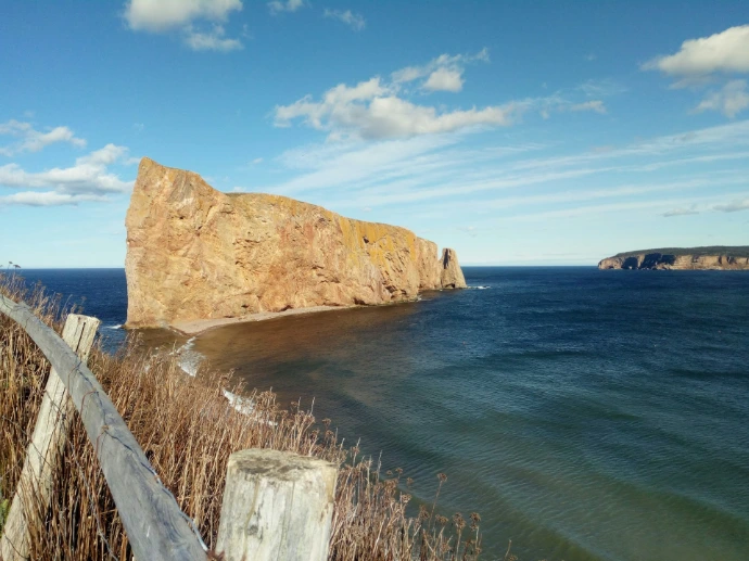 brown rock formation on blue sea under blue sky during daytime